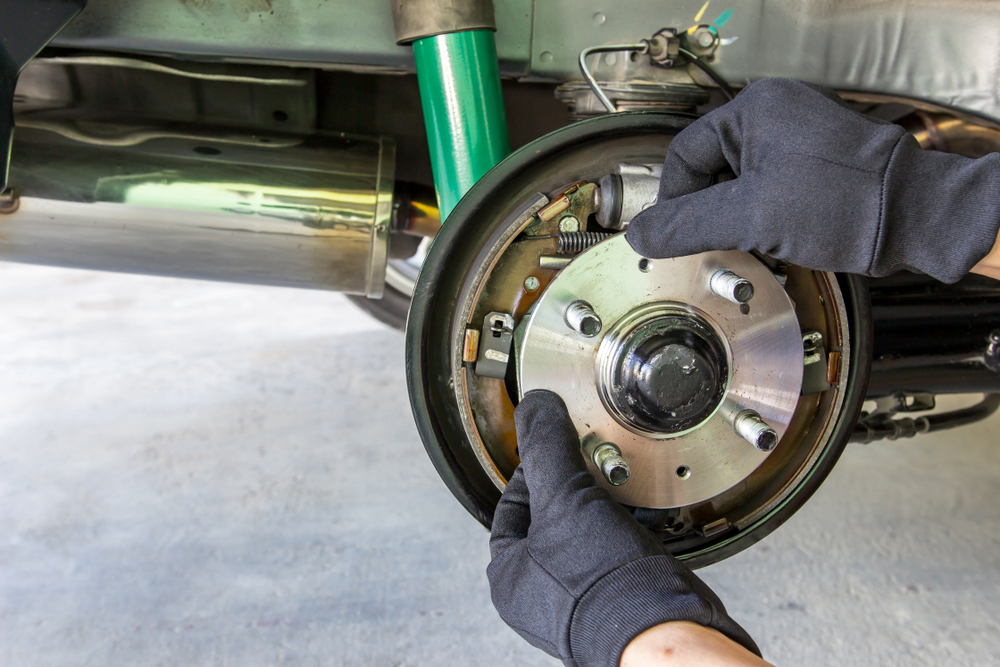 Close up image of man's hand change the bearing of wheel